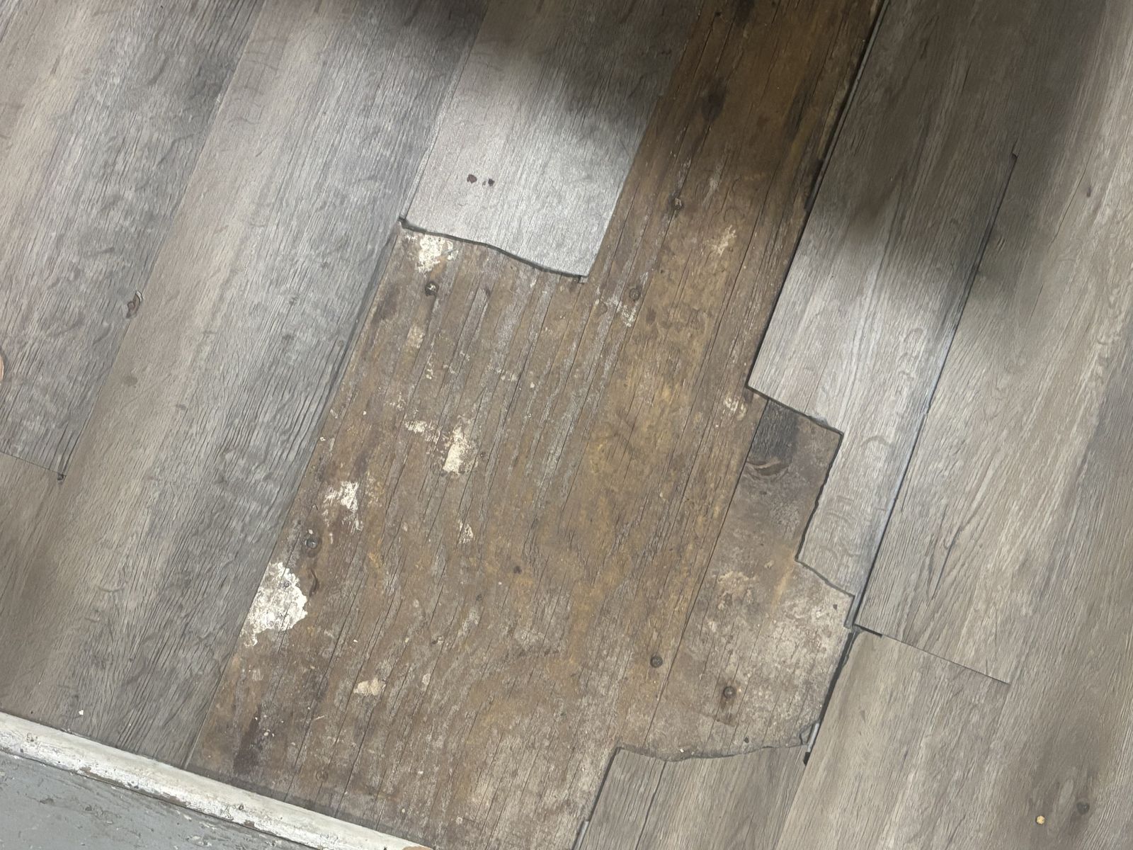 Damaged flooring before repair