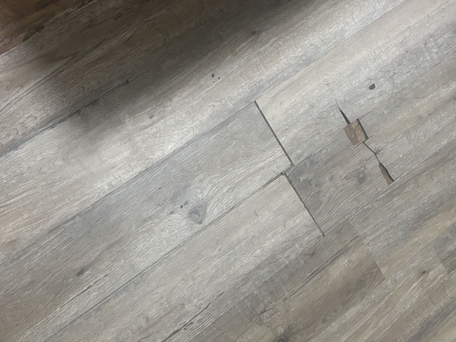 Damaged flooring before repair
