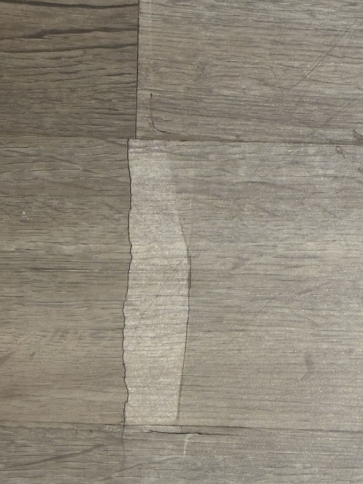 Damaged flooring before repair